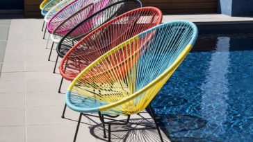 colorful acapulco chair next to the swimming pool