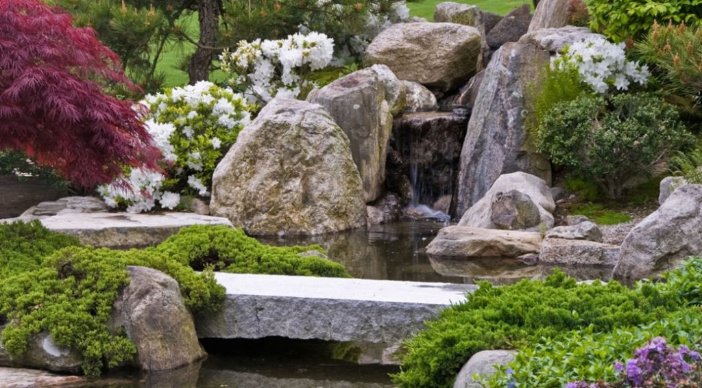 rock formation with waterfall in a zen garden