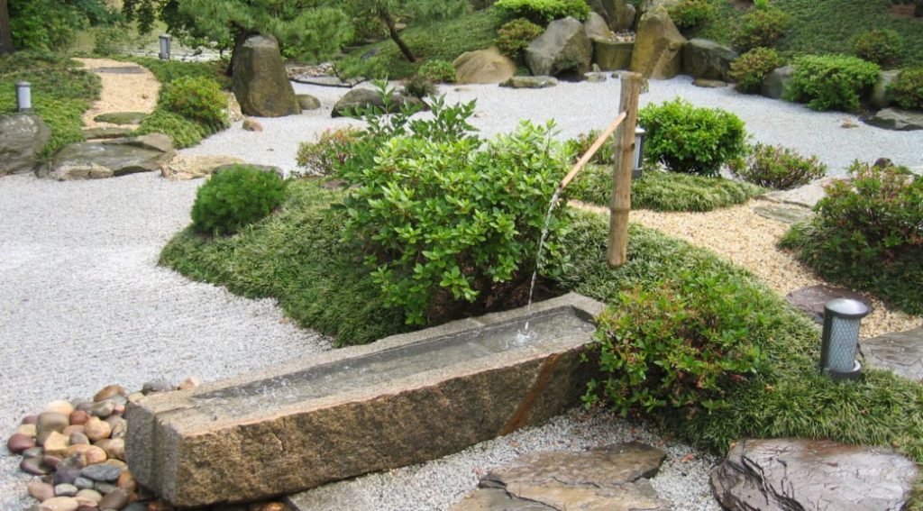 water fountain flowing in a japanese garden design
