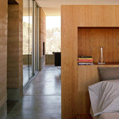 bookshelve on headboard in small bedroom by Rick Joy
