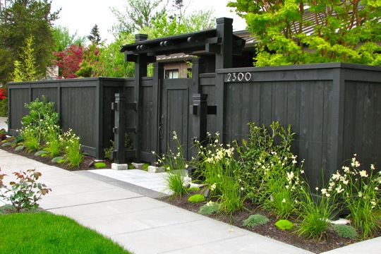 dark color japanese wood style fence with roof and gate