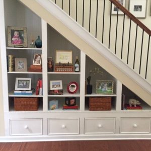 hidden storage cabinet and open space under straight staircase