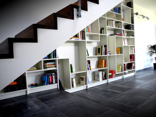 straight staircase with bookshelve underneath