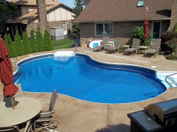 inground swimming pool in a modern back yard