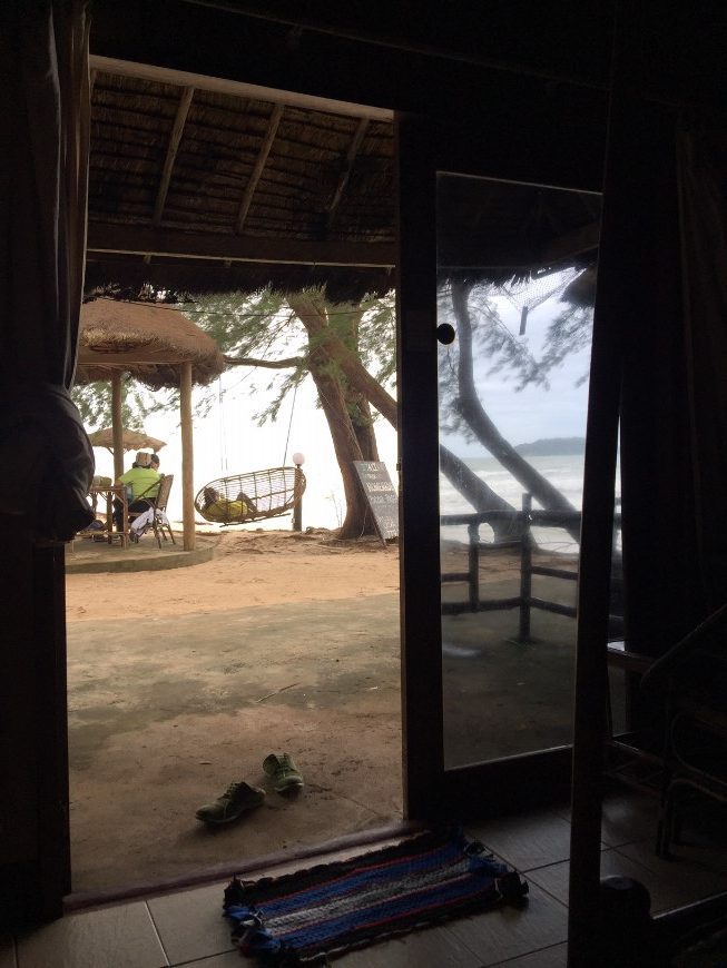 a view toward the beach of a beach town hut in cambodia