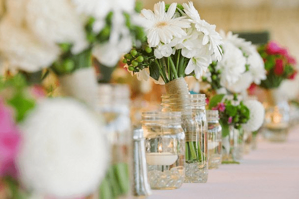 daisy flowers in a recycle glass tin