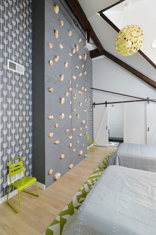 grey and green decor for kids bedroom with rock climbing wall