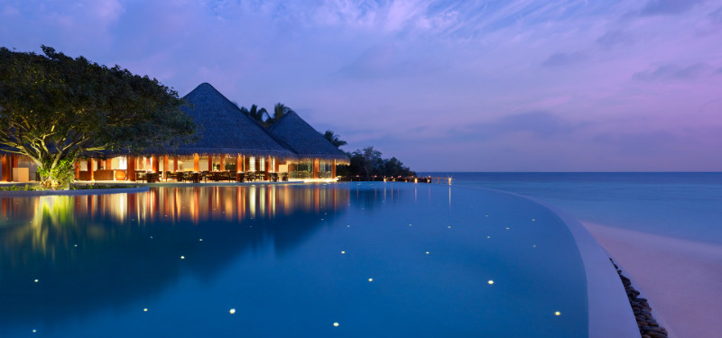 Dusit Thani Maldives swimming pool during evening time