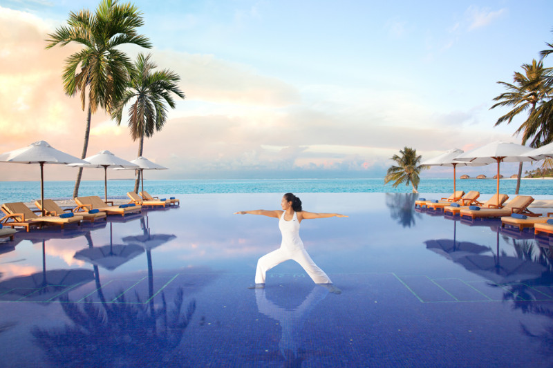 conrad hotel in maldives island with yoga instructor