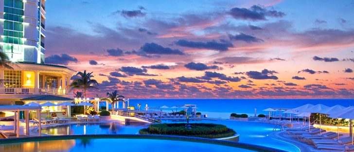 sandos cancun luxury hotel during twilight open infinity edge pool