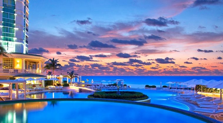 sandos cancun luxury hotel during twilight open infinity edge pool