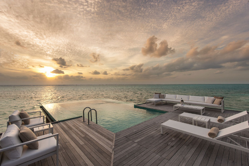 sunset in conrad maldives resort infinity pool